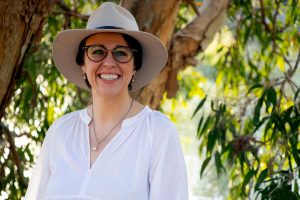 a woman in an a akubra hat and white shirt 